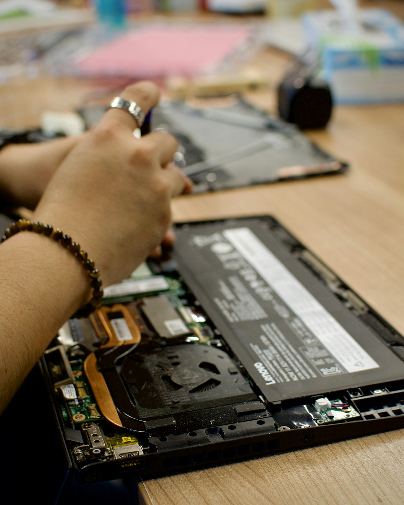 Manos de un técnico trabajando en el interior de un computador portátil